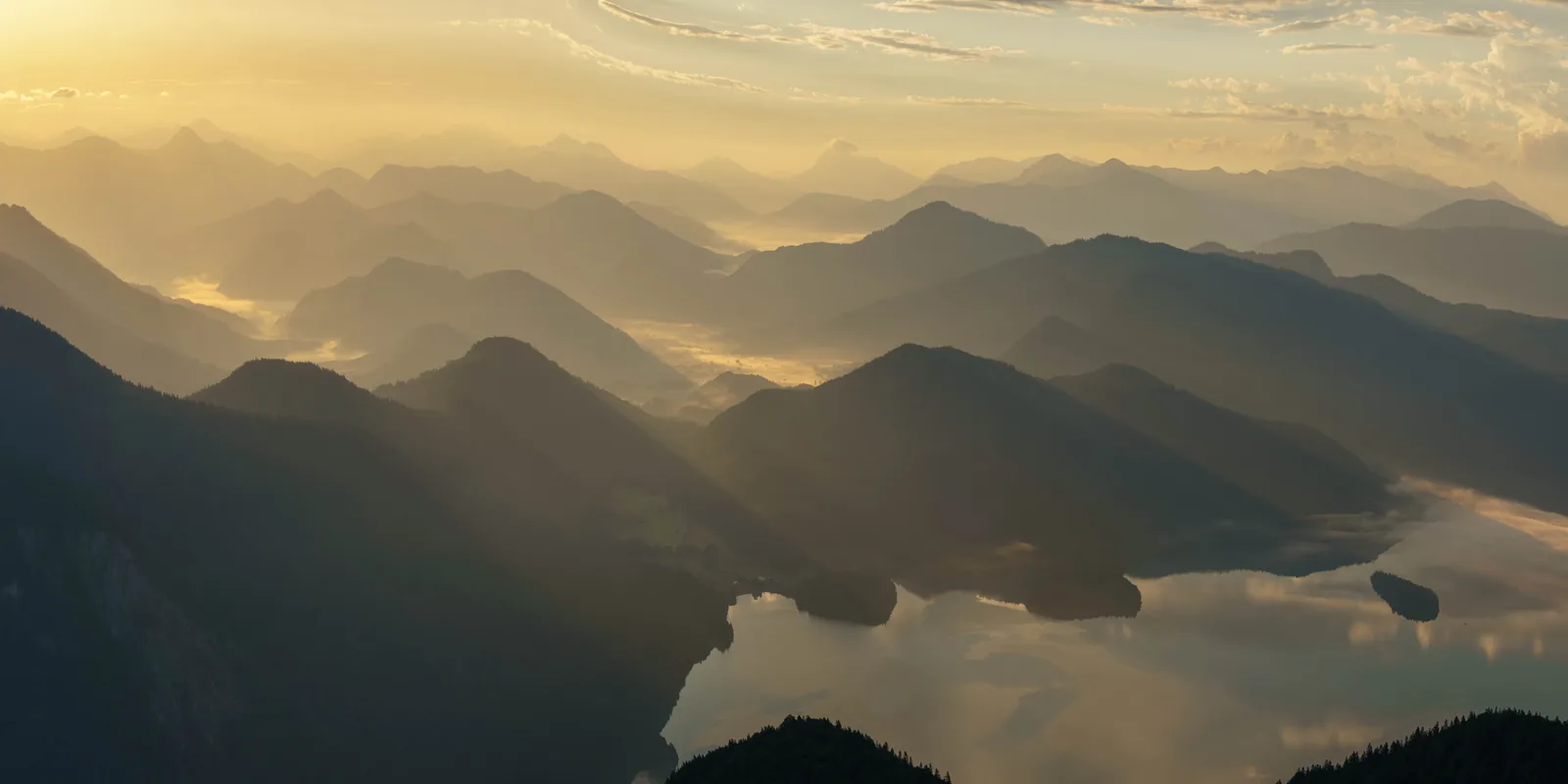 A sea of fog between mountain ridges in the morning light